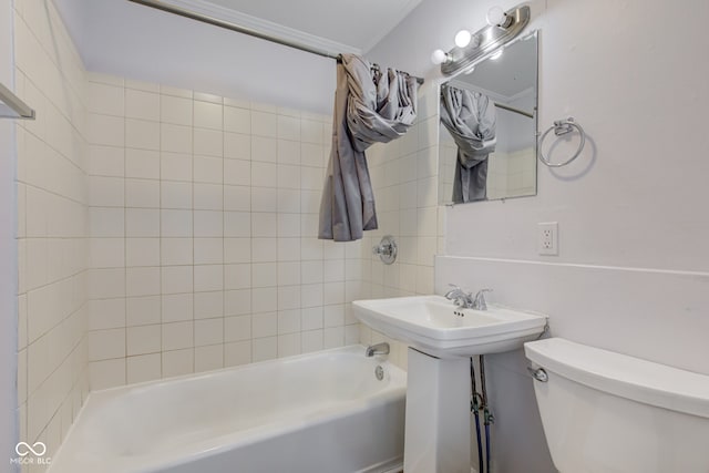 bathroom with shower / bath combination with curtain and toilet