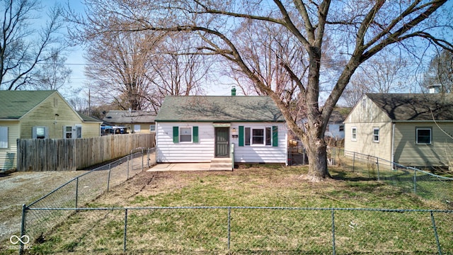 view of front of house with a fenced front yard and a front lawn