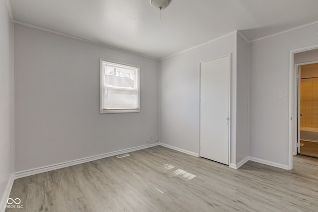 unfurnished bedroom with visible vents, baseboards, crown molding, and light wood-style floors