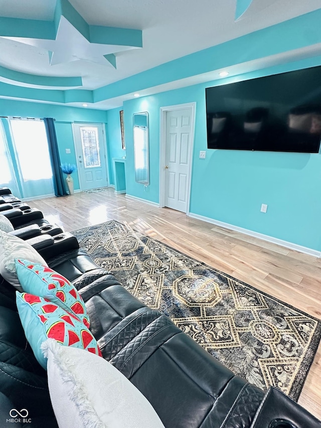 living area featuring baseboards and wood finished floors