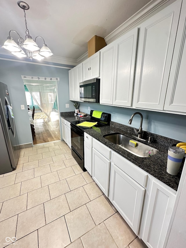 kitchen featuring light tile patterned flooring, a sink, appliances with stainless steel finishes, white cabinetry, and crown molding