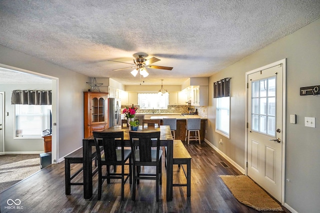 dining room featuring baseboards, dark wood-style flooring, and ceiling fan