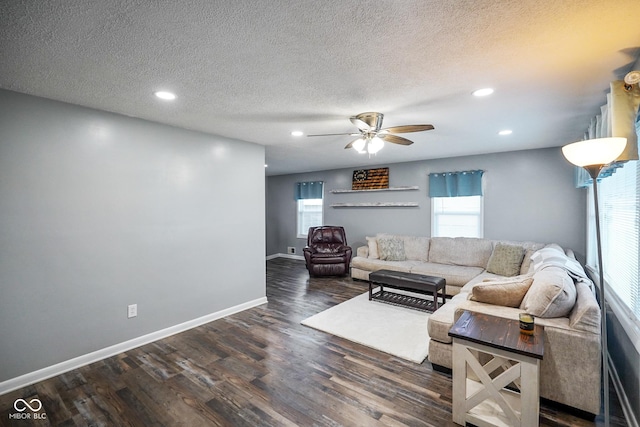 living area featuring dark wood-type flooring, recessed lighting, baseboards, and a textured ceiling