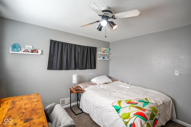 carpeted bedroom with visible vents, baseboards, and a ceiling fan