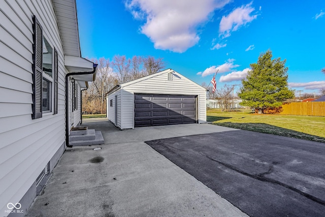 detached garage featuring fence