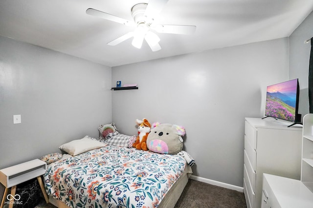 bedroom featuring dark colored carpet, baseboards, and a ceiling fan