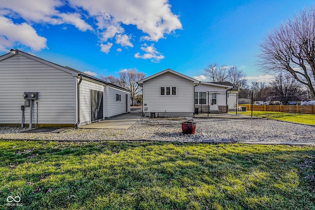 back of house featuring a patio, a yard, and fence