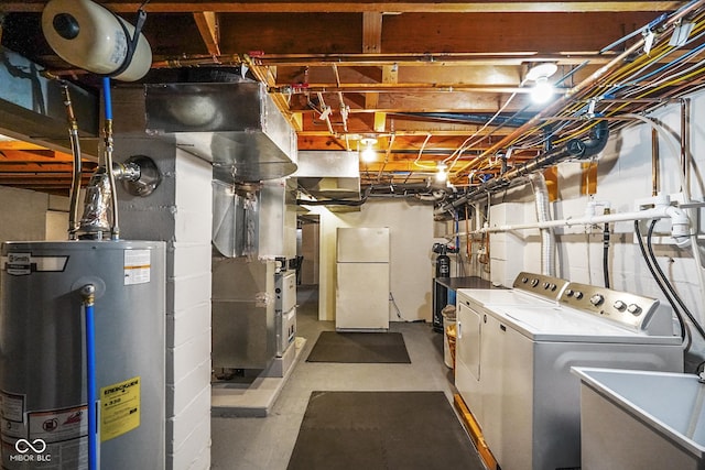 unfinished basement featuring washer and dryer, water heater, freestanding refrigerator, and a sink