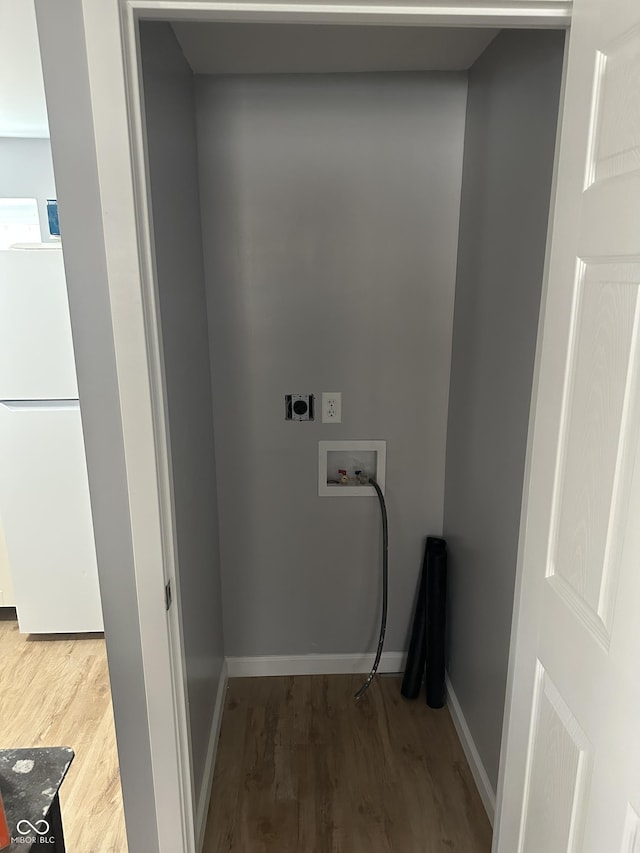 laundry area with baseboards, laundry area, hookup for a washing machine, wood finished floors, and hookup for an electric dryer