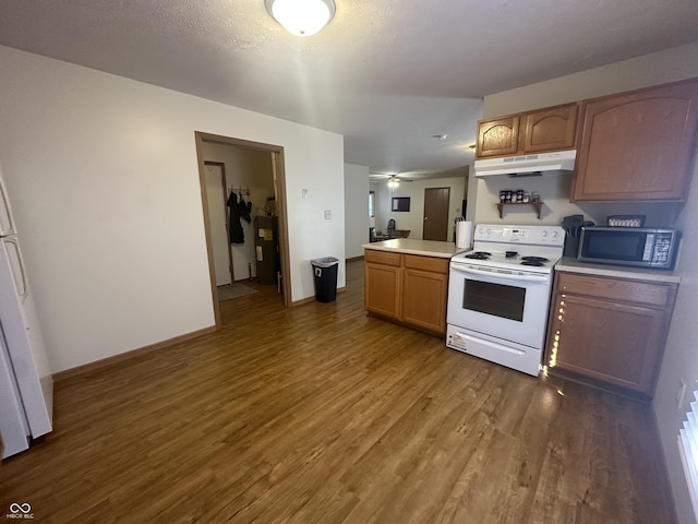 8 Gladiator Dr, Waynetown, IN 47990 - kitchen featuring wood finished floors, white appliances, under cabinet range hood, and light countertops