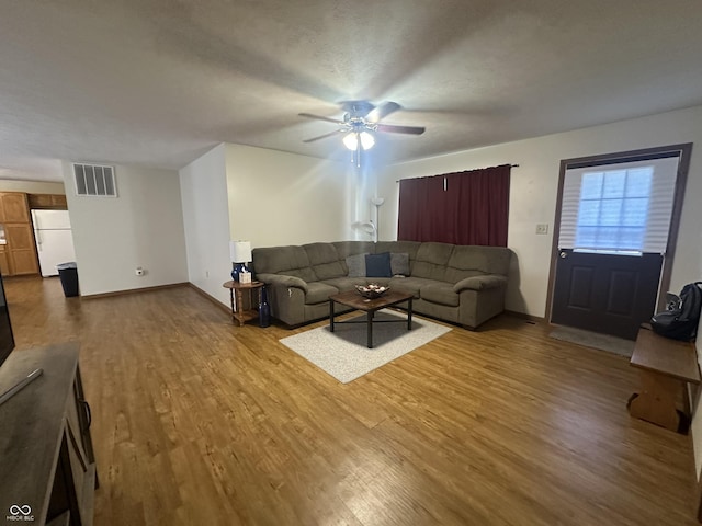 8 Gladiator Dr, Waynetown, IN 47990 - living room with dark wood-style floors, visible vents, ceiling fan, and baseboards