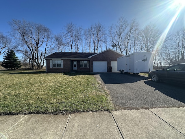 8 Gladiator Dr, Waynetown, IN 47990 - ranch-style home featuring a front yard, aphalt driveway, brick siding, and a garage
