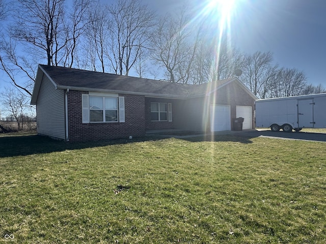 8 Gladiator Dr, Waynetown, IN 47990 - ranch-style home with a front lawn, concrete driveway, an attached garage, and brick siding