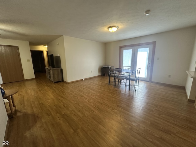 8 Gladiator Dr, Waynetown, IN 47990 - dining room featuring a textured ceiling, wood finished floors, french doors, and baseboards