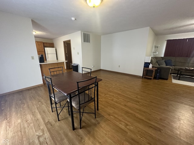8 Gladiator Dr, Waynetown, IN 47990 - dining room with wood finished floors, visible vents, and baseboards