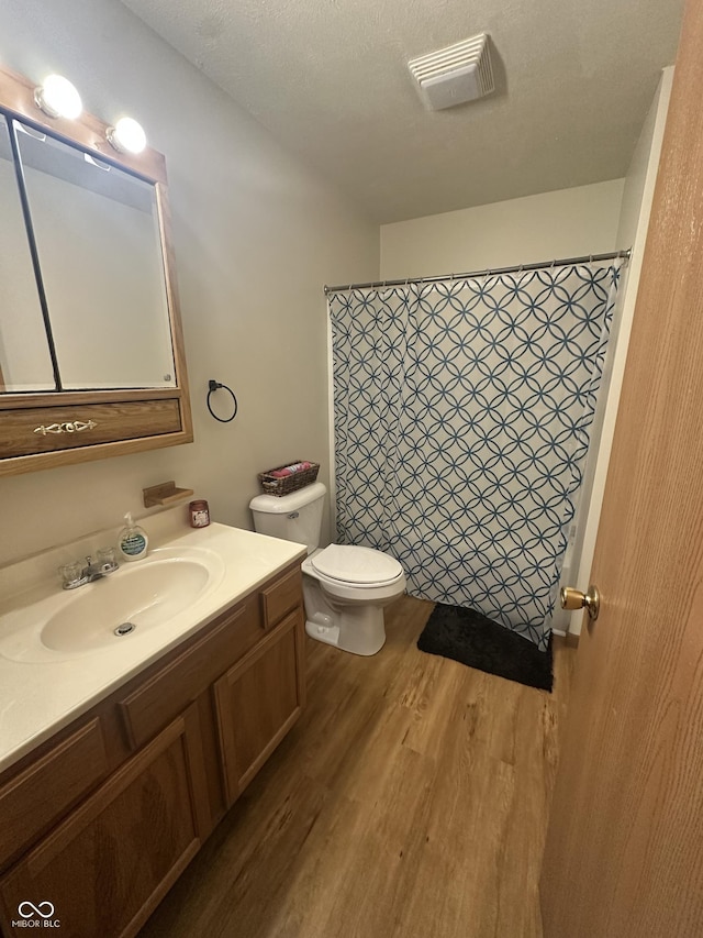 8 Gladiator Dr, Waynetown, IN 47990 - full bath featuring wood finished floors, toilet, curtained shower, vanity, and visible vents