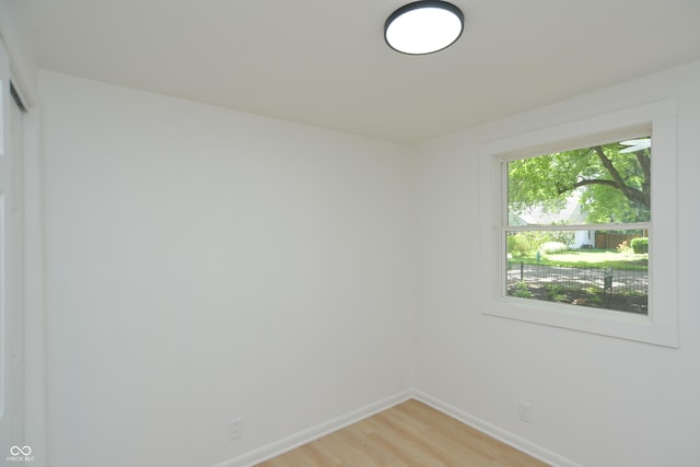 empty room featuring light wood-style flooring and baseboards