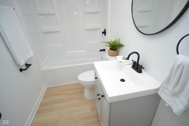 bathroom with toilet, vanity, shower / bathing tub combination, and wood finished floors