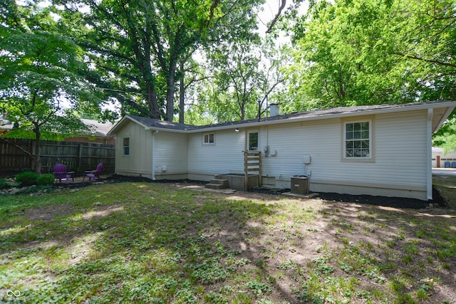 rear view of property featuring fence