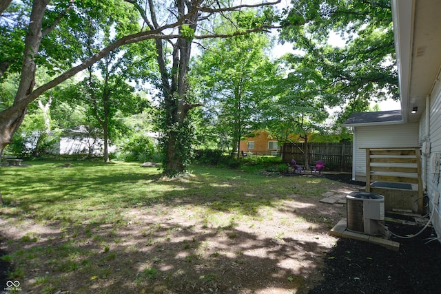 view of yard featuring cooling unit and fence