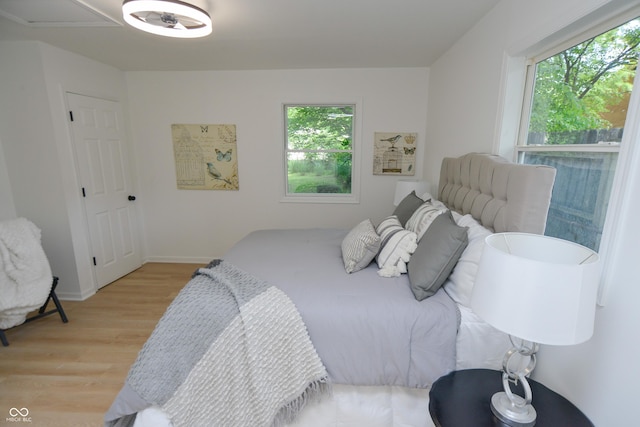 bedroom featuring light wood-style flooring and baseboards