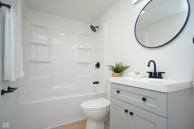 full bathroom featuring toilet, vanity, shower / bathtub combination, wood finished floors, and a textured ceiling