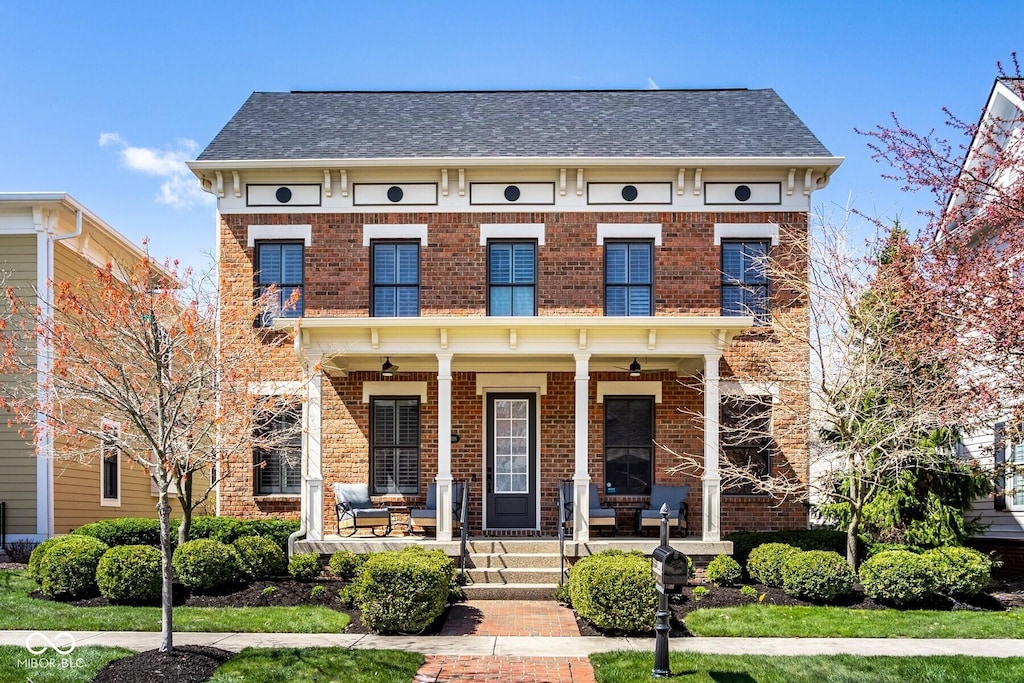 13018 Deerstyne Green St, Carmel, IN 46032 - italianate-style house with brick siding, a porch, and roof with shingles