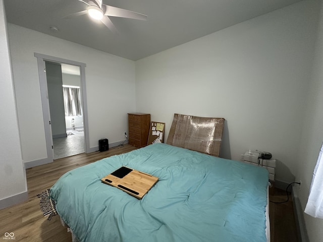 bedroom with baseboards, wood finished floors, and a ceiling fan