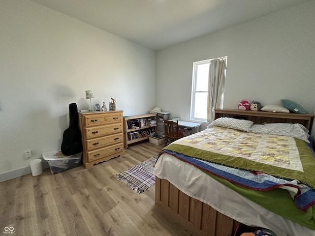 bedroom with baseboards and light wood-style floors