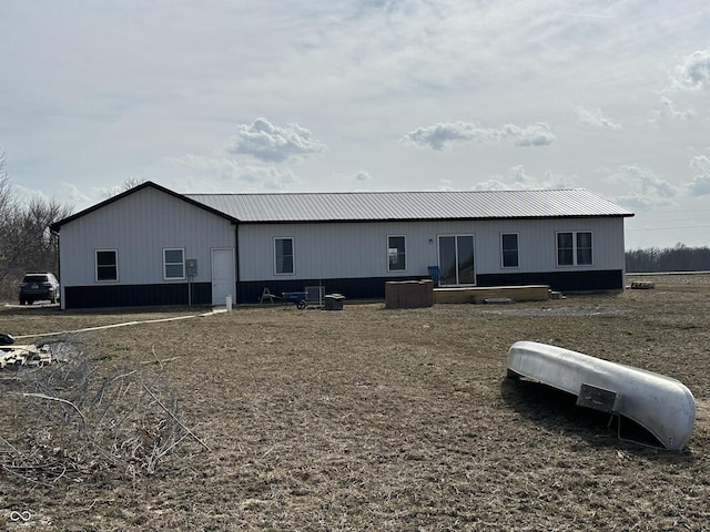 rear view of house with metal roof and central air condition unit