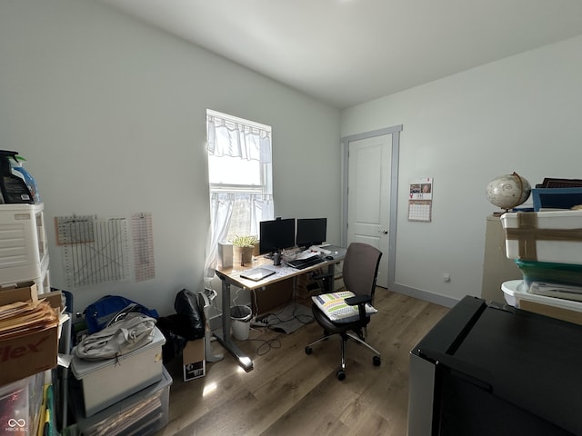 office featuring light wood-type flooring and baseboards