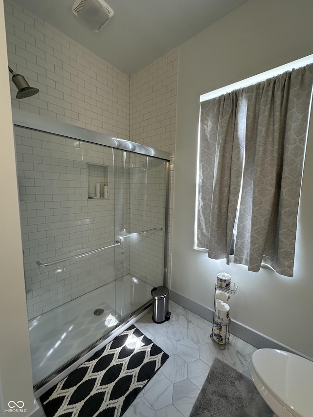 full bath featuring visible vents, marble finish floor, a stall shower, and baseboards