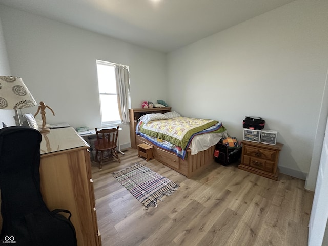 bedroom featuring baseboards and light wood-style floors