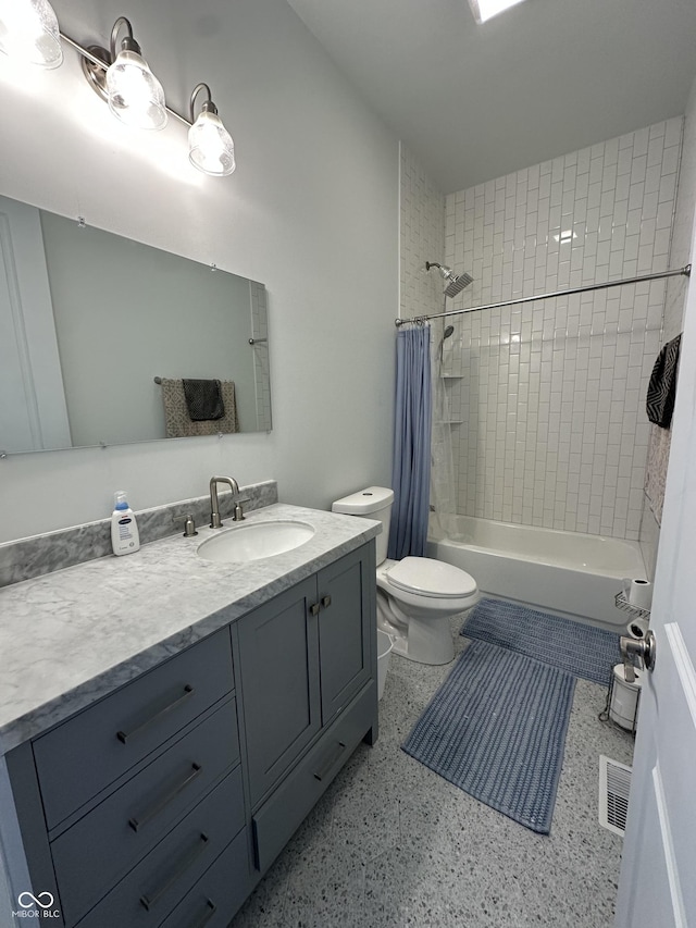 full bathroom featuring vanity, shower / bath combo with shower curtain, toilet, and visible vents