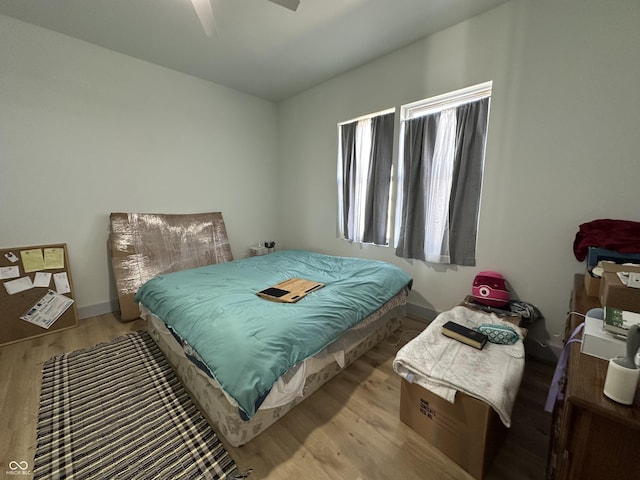 bedroom with a ceiling fan and wood finished floors