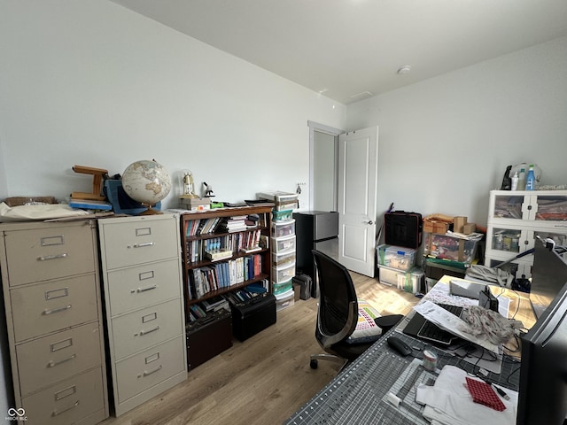 home office with light wood finished floors