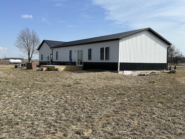 exterior space featuring a wooden deck and metal roof