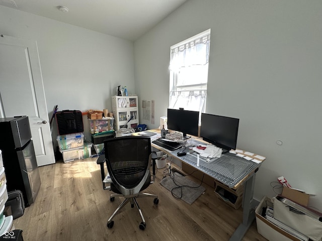 office with light wood-type flooring