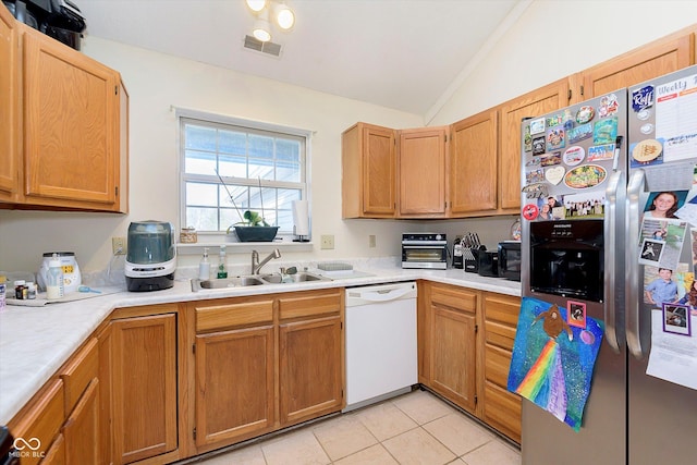 kitchen featuring visible vents, a sink, white dishwasher, stainless steel fridge with ice dispenser, and vaulted ceiling