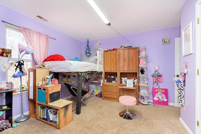 carpeted bedroom featuring visible vents and baseboards