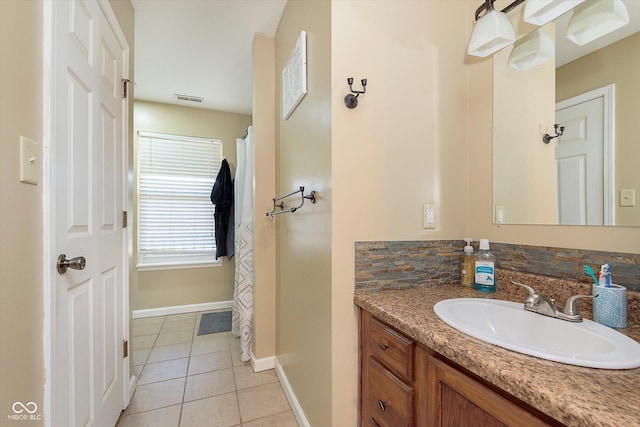 full bath with tile patterned floors, visible vents, vanity, and baseboards