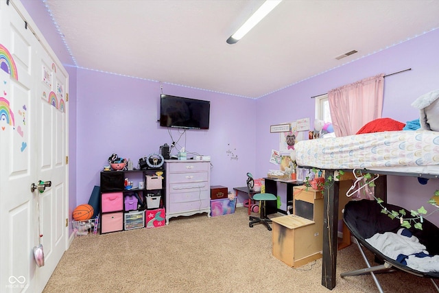 carpeted bedroom featuring visible vents