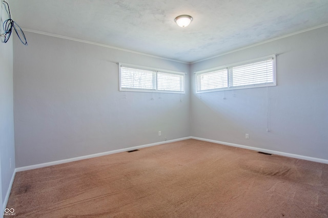 unfurnished room featuring visible vents, light carpet, and baseboards