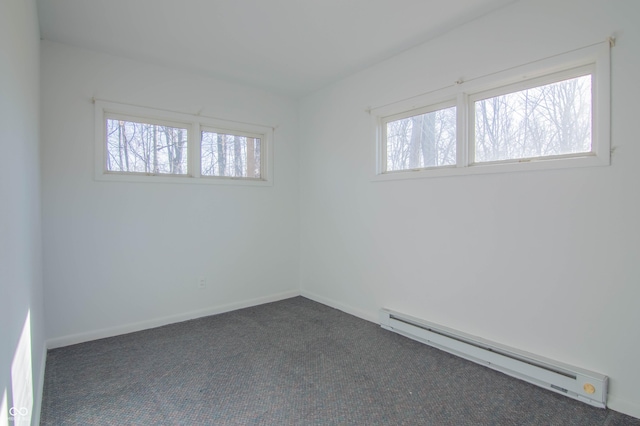 carpeted empty room with baseboards and a baseboard radiator