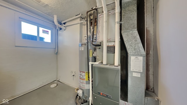 utility room featuring heating unit and gas water heater