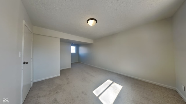 unfurnished bedroom featuring baseboards, carpet, and a textured ceiling