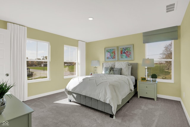 carpeted bedroom with visible vents and baseboards