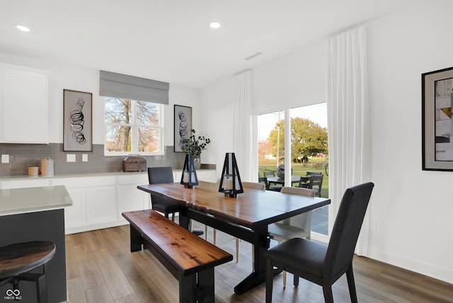 dining room with recessed lighting, light wood-style floors, and a wealth of natural light