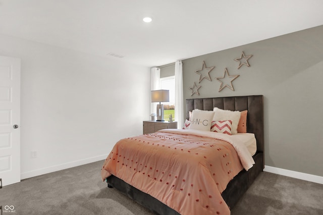 carpeted bedroom with visible vents and baseboards