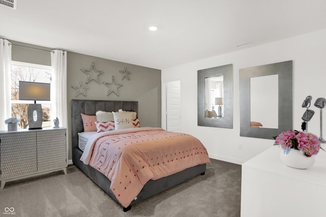 bedroom with visible vents, baseboards, and carpet flooring